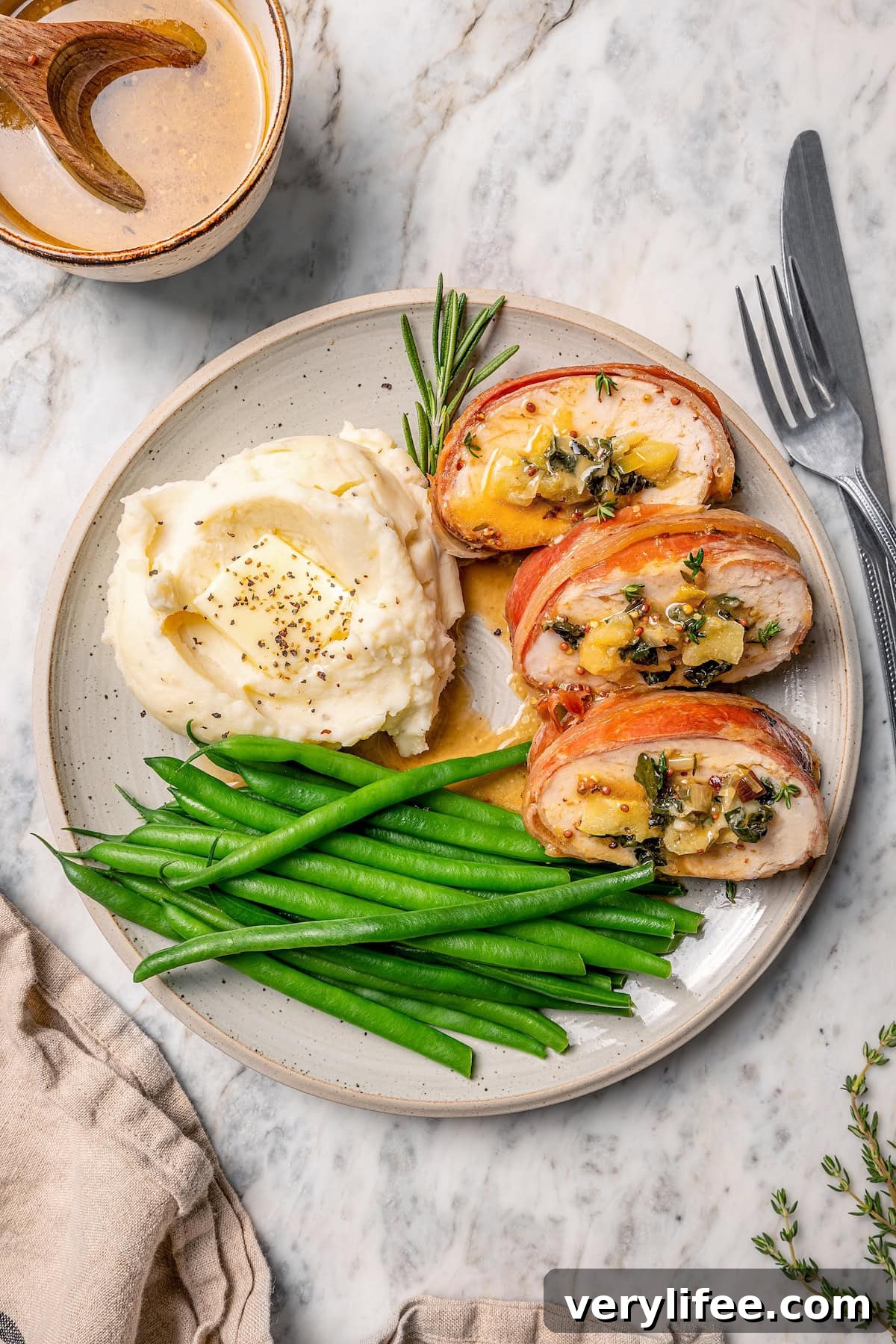 Prosciutto-Wrapped Turkey Tenderloin Stuffed with Apples, Kale 9 Plate of prosciutto-wrapped stuffed turkey tenderloin, green beans, and mashed potatoes.