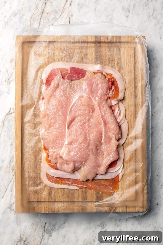 Prosciutto-Wrapped Turkey Tenderloin Stuffed with Apples, Kale 4 Turkey tenderloin set over layer of prosciutto.