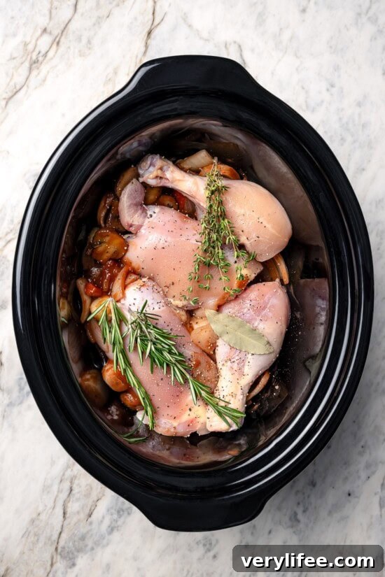 Ingredients added to slow cooker for coq au vin.