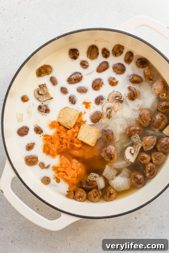 Creamy Pumpkin Ginger Coconut Soup — Dairy-Free 5 Ingredients in a pot for pumpkin soup with canned pumpkin, ginger, and coconut milk