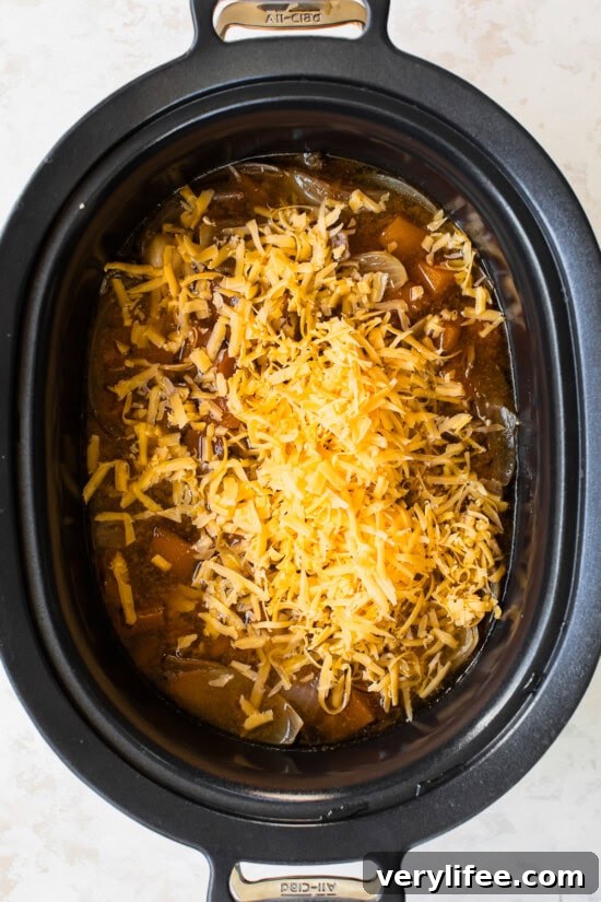 Butternut Squash Cheddar Beer Soup in the slow cooker with cheddar