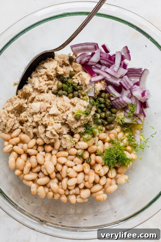 Tuna White Bean Salad in a bowl with capers and onion