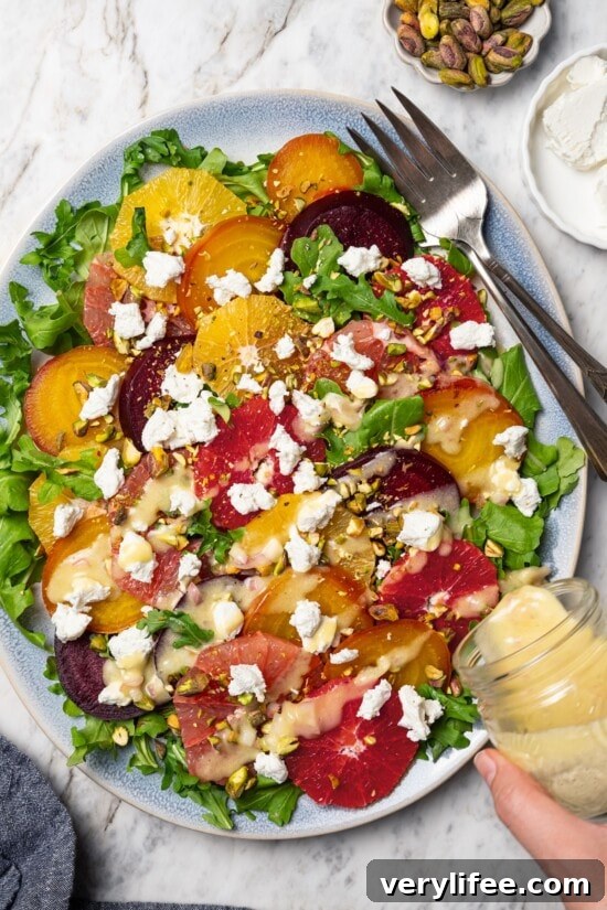 Roasted Beet Salad with Citrus and Goat Cheese 11 Pouring vinaigrette onto roasted beet and citrus salad.