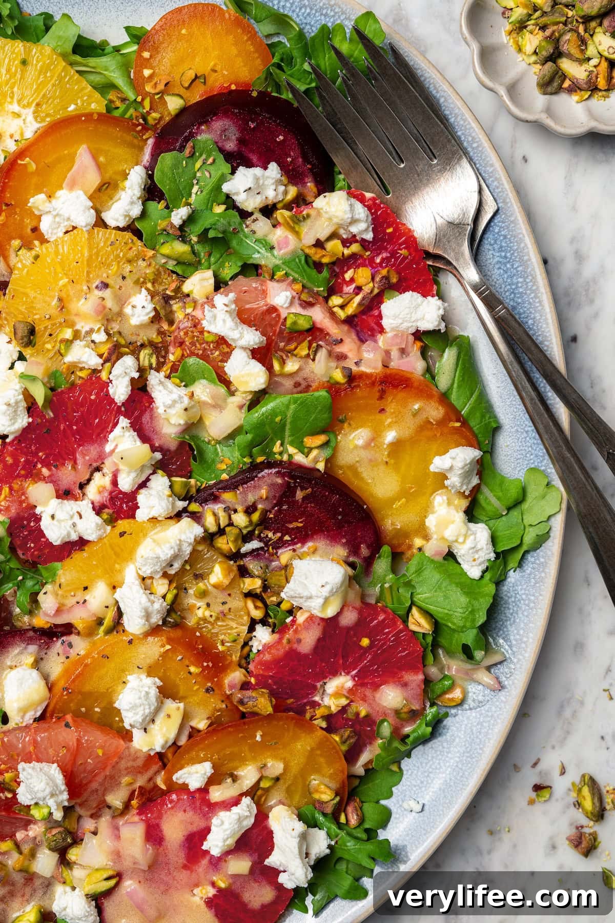 Roasted Beet Salad with Citrus and Goat Cheese 12 Roasted beet and citrus salad on platter with two forks.