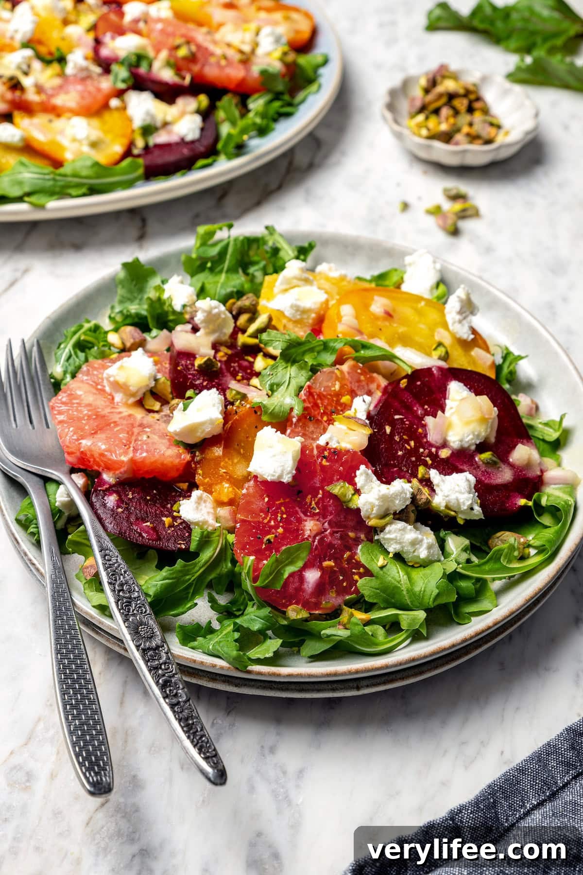 Roasted Beet Salad with Citrus and Goat Cheese 13 Roasted beet and citrus salad on plate with two forks.