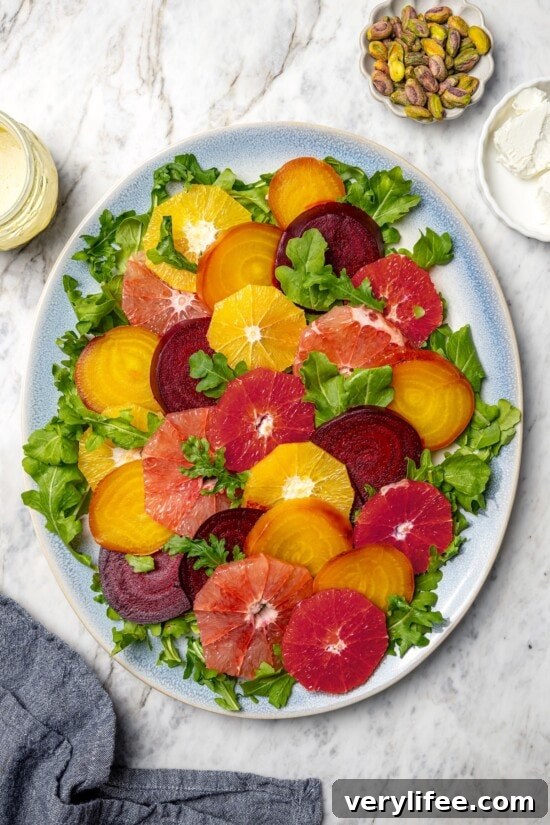 Roasted Beet Salad with Citrus and Goat Cheese 10 Sliced beets and citrus fruit on platter with arugula.