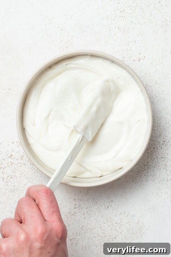Spreading Whipped Feta Dip on a plate