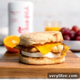 Copycat Chick-fil-A egg white grill sandwich on wood cutting board.