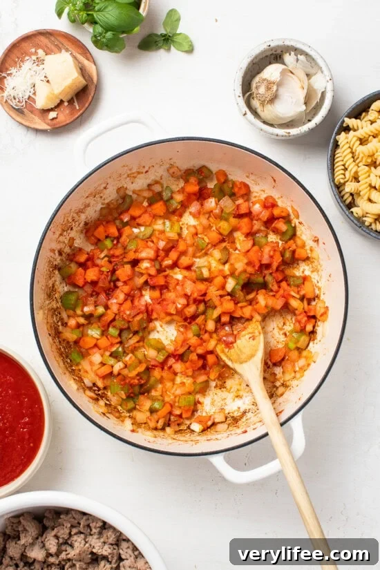 sauteing veggies and tomato paste in skillet