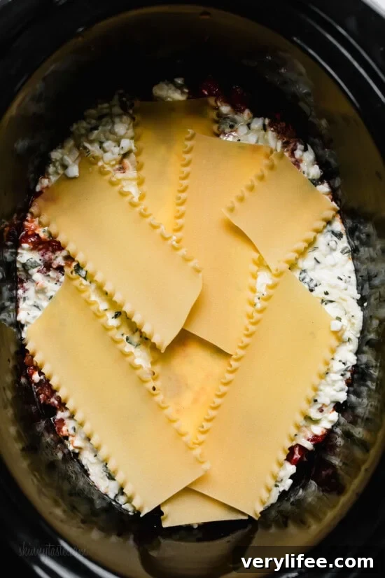 Slow Cooker Lasagna Recipe: Cheesy, Tender Layers 9 Layer the lasagna noodles in the slow cooker