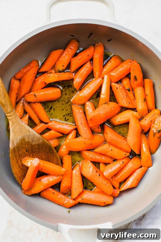 Honey-Glazed Carrots Recipe with Butter and Herbs 7 Cooked Carrots in a skillet