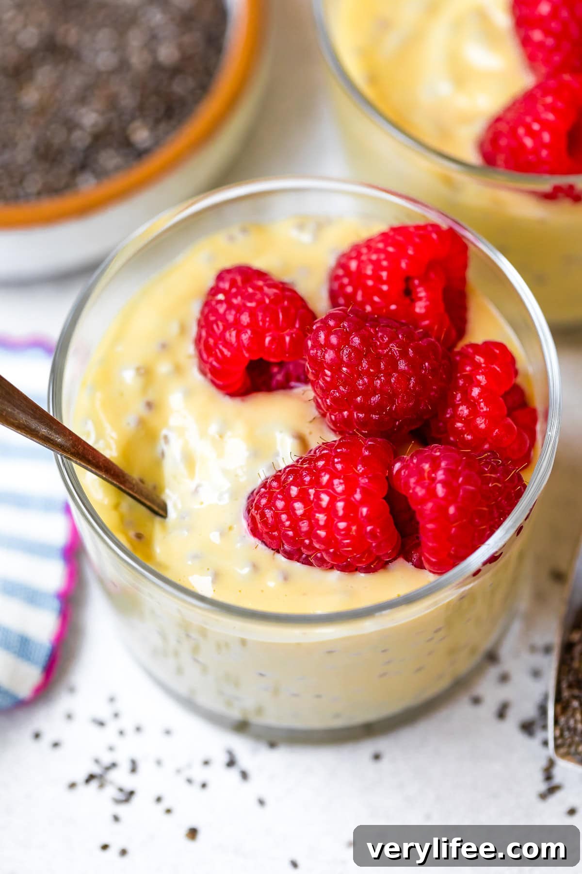 raspberries over Passion Fruit Chia Pudding in cups