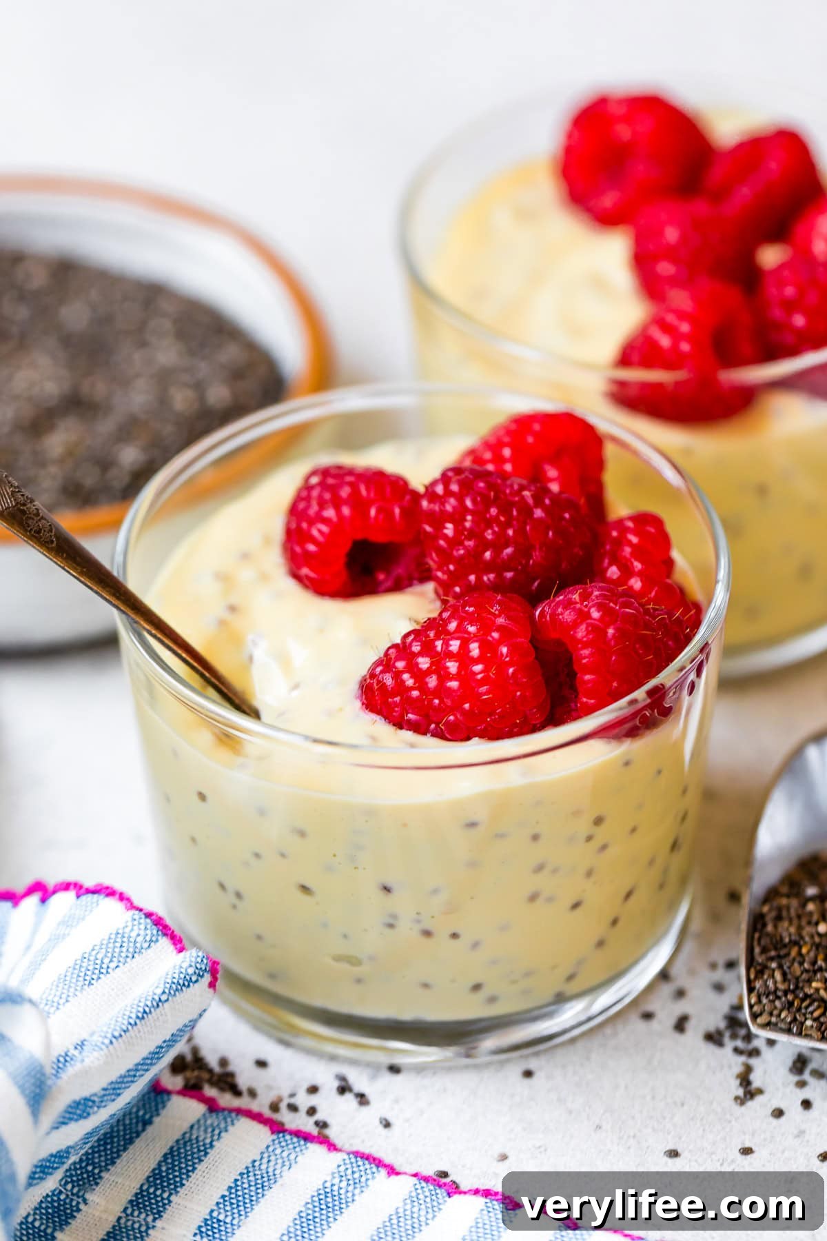raspberries over Passion Fruit Chia Pudding in cups