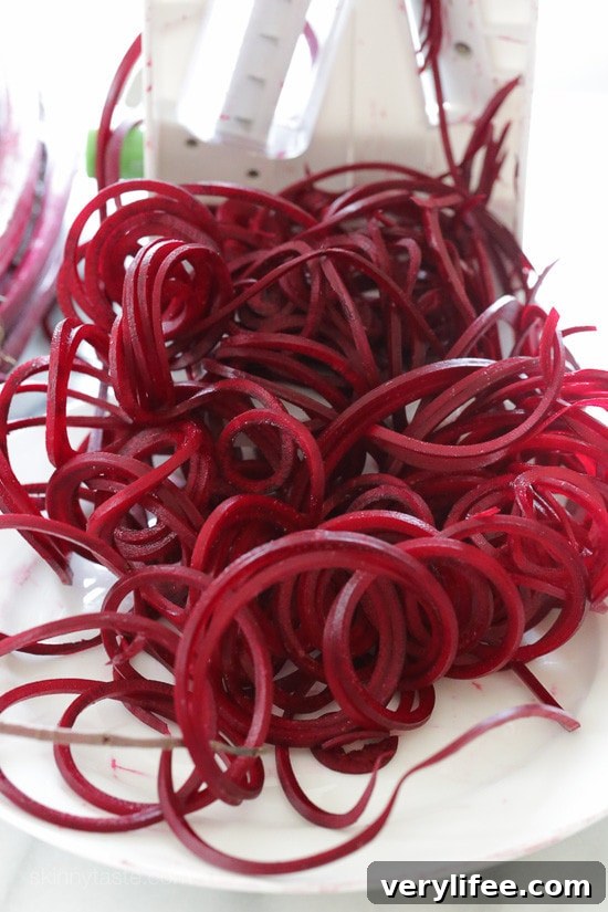Spiralized beets in a bowl with mandarins and mint
