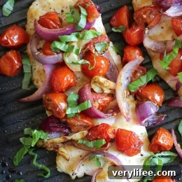 Sheet Pan Chicken with Roasted Tomatoes and Red Onions 3 Finished plate of chicken with roasted tomatoes and red onions.
