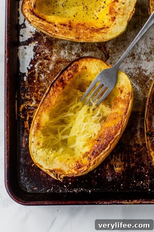 fork shredding strands of spaghetti squash