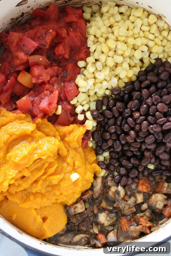 Pumpkin, diced tomatoes, corns, and beans in a pot