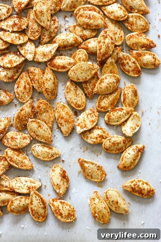 These Spicy Pumpkin Seeds are a fun twist on roasted pumpkin seeds. They make a tasty, filling snack on their own and a great salad topper. Spicy pepitas on a marble countertop