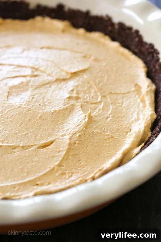 An EASY Fall dessert, this no-bake cheesecake is light and fluffy, made with pumpkin and spices. Quick and simple to make in under 10 minutes, if you use ready made crust.