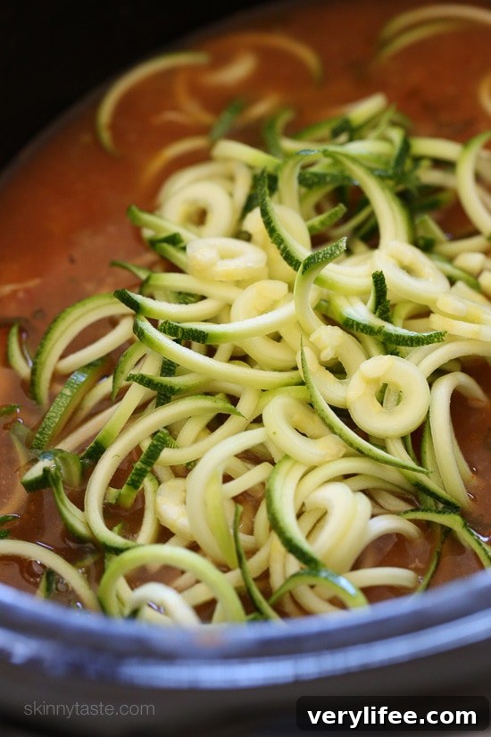 Bowl of Chipotle Chicken Zucchini Fideo Soup with avocado and cilantro