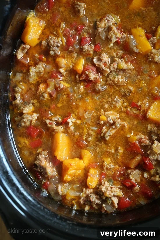 Bowl of Paleo Jalapeno Popper Chicken Chili garnished with avocado