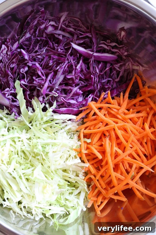 Cabbage slaw ingredients combined in a bowl.