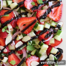 This easy light summer salad, made with cucumbers, strawberries, almonds and fresh herbs is great alongside grilled chicken, fish or for a light lunch you can double the serving and add some goat cheese to the mix or serve it over quinoa for more protein.