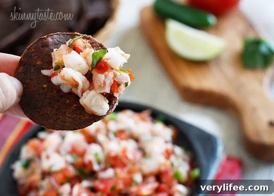 Skinny Shrimp Salsa is so good, you might not want to share! Made with shrimp, tomatoes, cilantro, red onion and lime juice. Bring this to a party and watch it disappear!