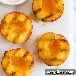 Grilled peaches served with honey and yogurt — a low-calorie summer dessert