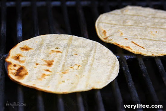 Blackened Fish Tacos with Mango Cabbage Slaw Recipe 4 Two corn tortillas on a grill