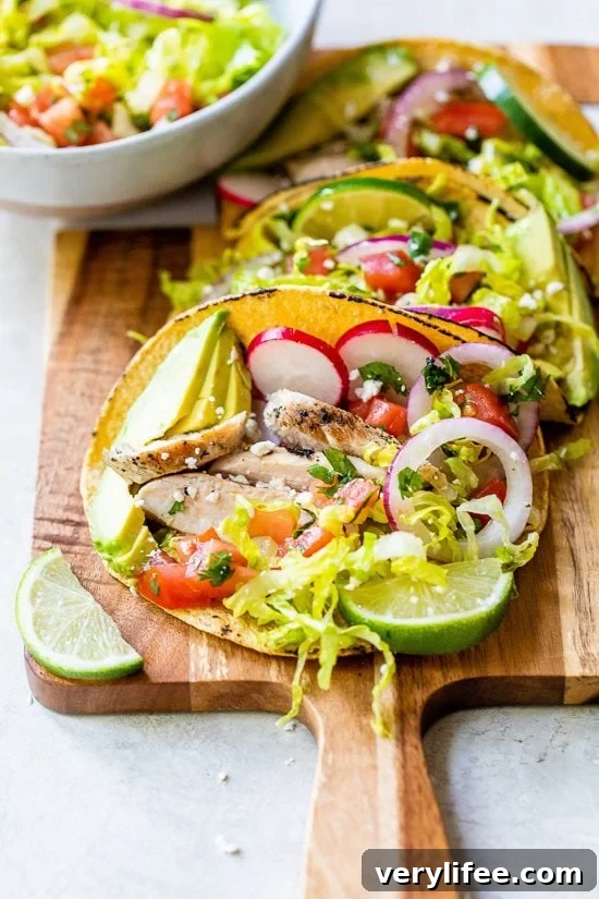 Grilled Chicken Tacos with Avocado and Cotija Slaw 2 Grilled Chicken Tacos with Lettuce Slaw, Avocado and Cotija