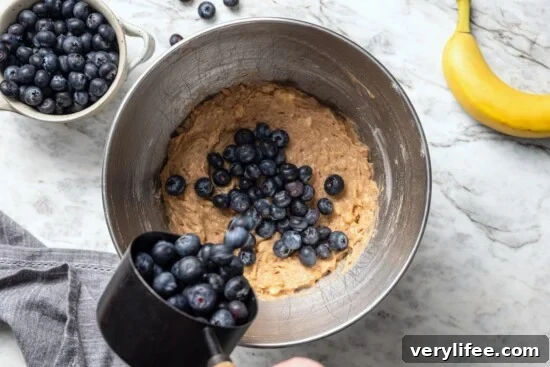 Moist Blueberry Banana Bread Recipe 6 Adding blueberries to banana bread batter.