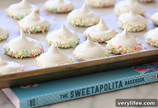 Sprinkle Dipped Meringues Sprinkle Dipped Meringues – Melt-in-your-mouth meringues dipped in white chocolate and sprinkles!