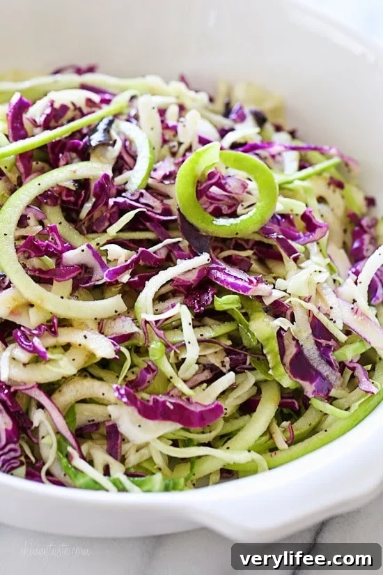Spiralized Apple and Cabbage Slaw This beautiful apple and cabbage slaw is sweet, bright and crisp, the perfect side dish to any meal and great to bring to a potluck.