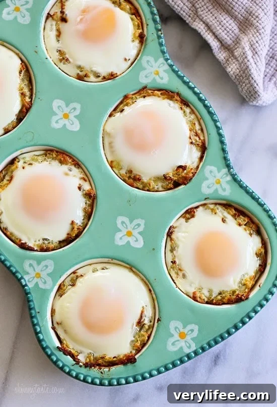 Baked Eggs in Spaghetti Squash Nests A muffin tin with a nest of spaghetti squash and a baked egg in each tin