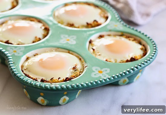 Spaghetti Squash Nests with Baked Eggs Recipe 4 A muffin pan with spaghetti squash mixture and a baked egg in each tin