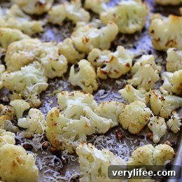 Roasted cauliflower brings out its nuttiness and caramelizes the edges. Toss with garlic, lemon juice and olive oil and top with freshly grated Parmesan and lemon zest after roasting.