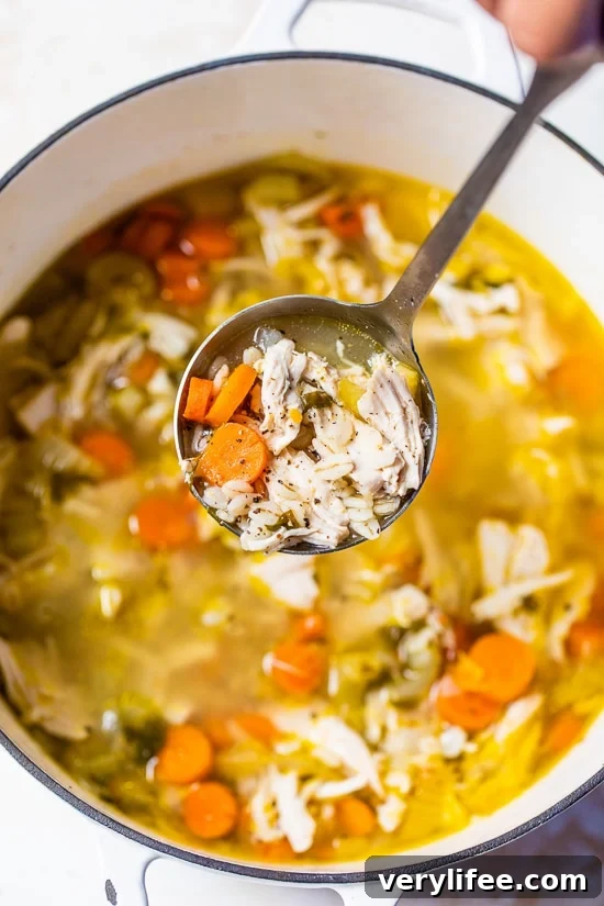 Classic Chicken and Barley Soup Recipe 3 Chicken Barley Soup in a pot with ladle.