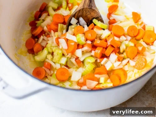 Classic Chicken and Barley Soup Recipe 6 vegetables in a dutch oven.