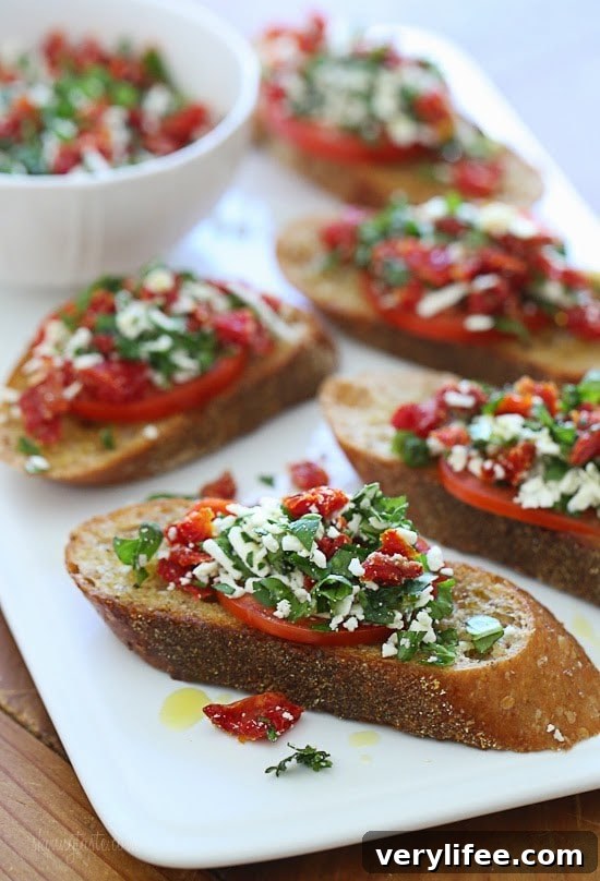 Two Tomato Bruschetta with roma and sun-dried tomatoes, basil and feta on toasted whole wheat bread.