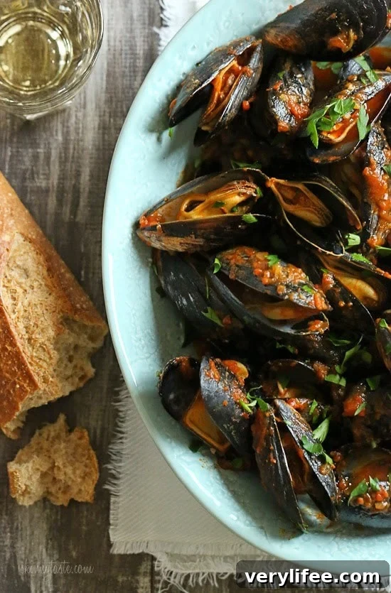 Mussels in a spicy red marinara sauce – simple and elegant, best served with lots of whole wheat crusty bread for dipping into the delicious sauce.