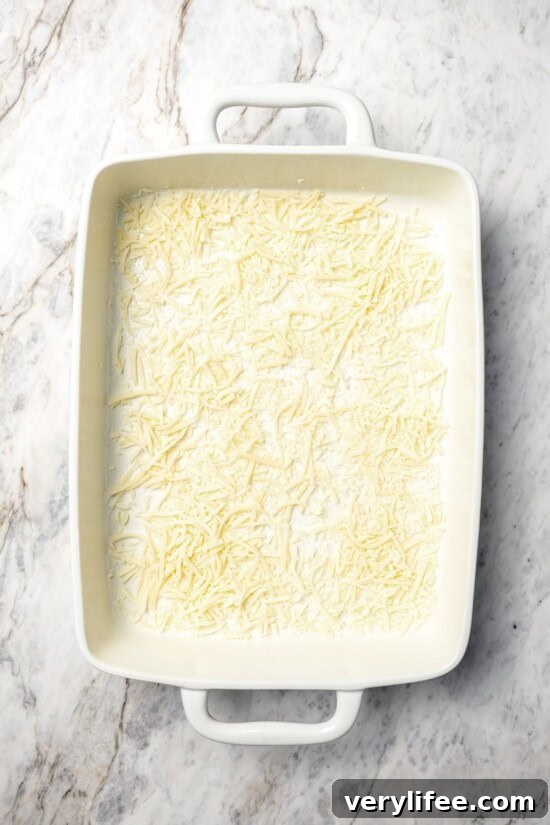 Shredded mozzarella in bottom of baking dish.