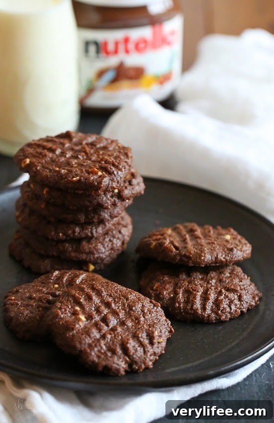 These cookies are amazing!!! And so easy to make,  you don't even need a mixer! Only 5 ingredients including Nutella, Chunky Almond Butter and Cocoa Powder.