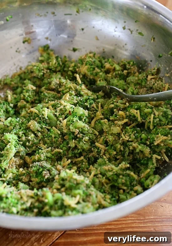 A mixture of chopped broccoli, grated cheese, scallions, and bread crumbs in a mixing bowl