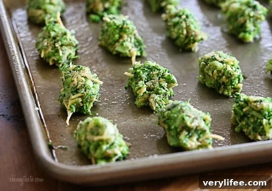 A baking sheet with uncooked broccoli and cheese tots