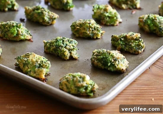 A baking sheet with cooked broccoli and cheese tots