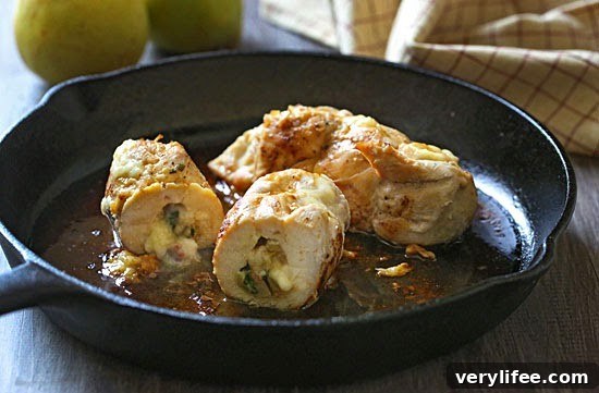Stuffed chicken breast sliced to show pear and brie filling