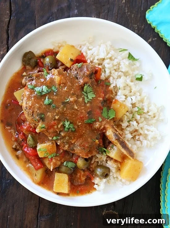 These slow cooker pork chops are seasoned with Latin spices in a flavorful sauce with tomatoes, olives, peppers and potatoes. They literally fall off the bone when they come out of the slow cooker!