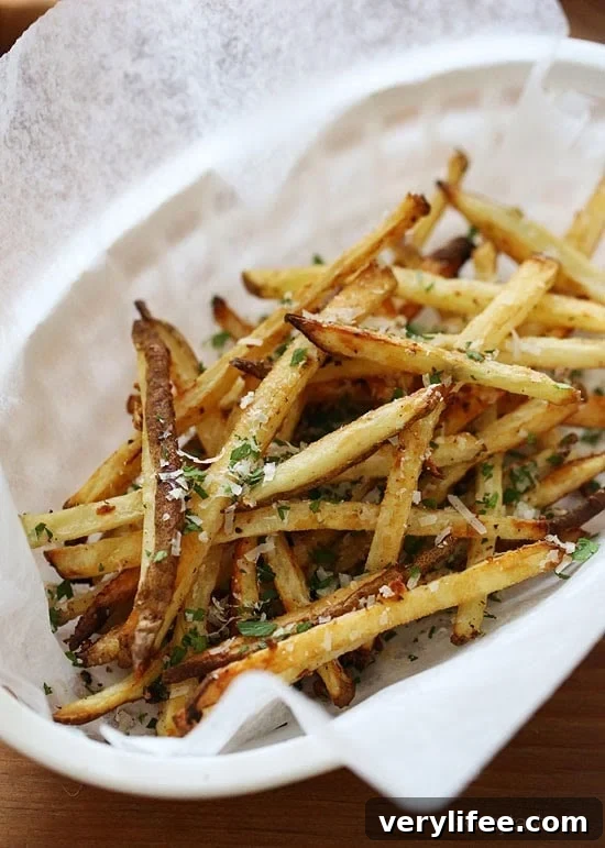 These delicious fries are baked in the oven with garlic, a little olive oil, kosher salt and black pepper, then sprinkled with freshly grated Parmesan and parsley – to die for!