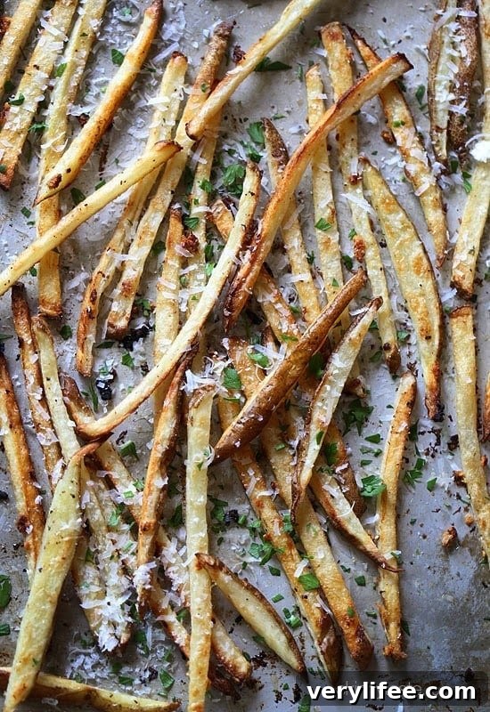 These delicious fries are baked in the oven with garlic, a little olive oil, kosher salt and black pepper, then sprinkled with freshly grated Parmesan and parsley – to die for!